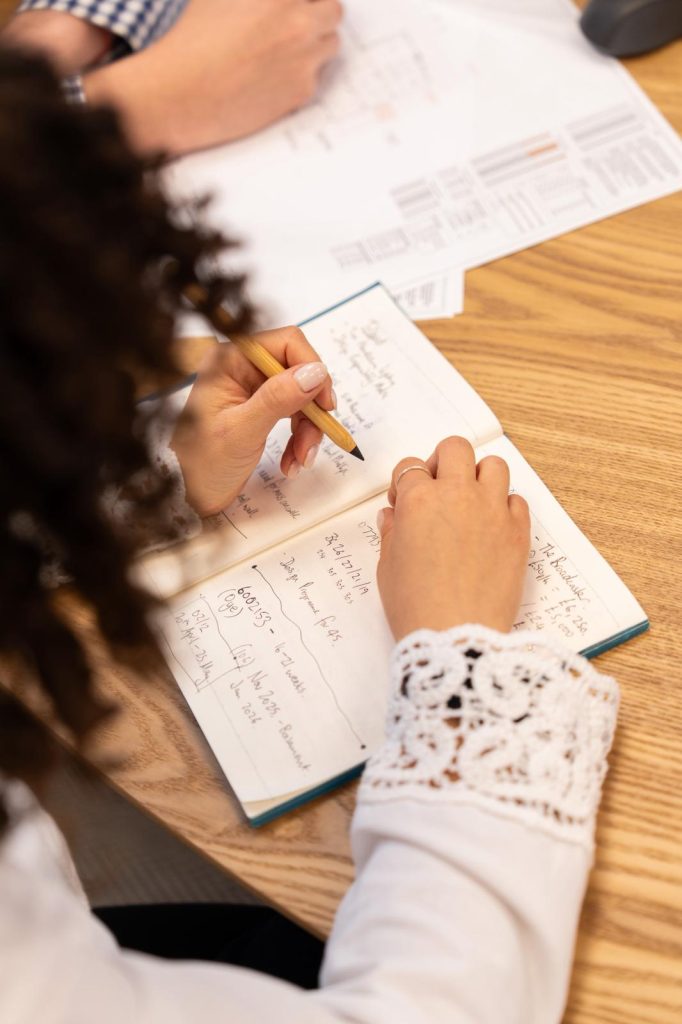 A Studio80six team member taking notes during a project discussion